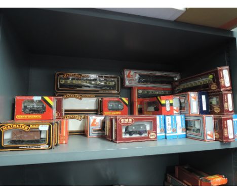 A shelf of Lima, Airfix, Hornby and Mainline 00 gauge rolling stock, all boxed, 37 items