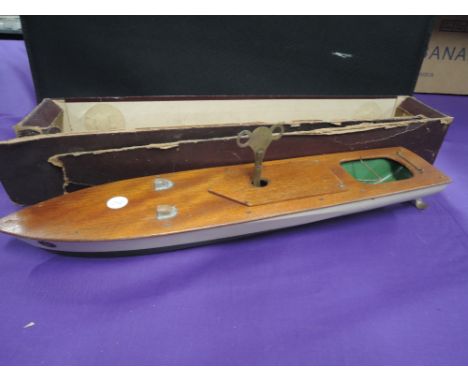 A mid 20th century wooden and clockwork model boat, marked K, with key in boxCONDITION REPORT OF MOTORWinds up and runs once 