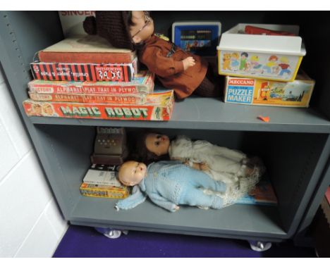 Two shelves of vintage toys, games and dolls includng Magic Robot, Singer sewing machine, Fisher Price etc