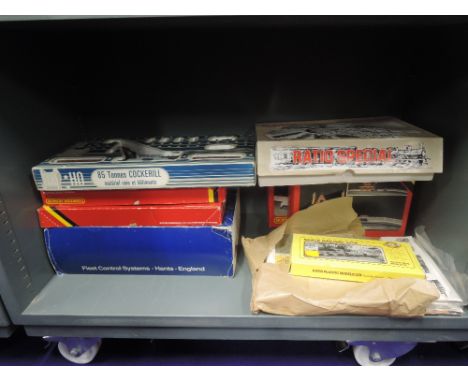 A shelf of 00 gauge HO scale accessoriesand kits, most boxed