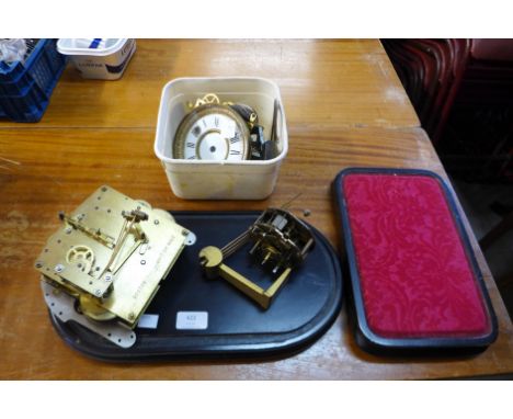 A box of clock movements and plinths