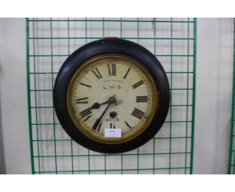 A beech circular wall clock bearing an L.M.S. inscription