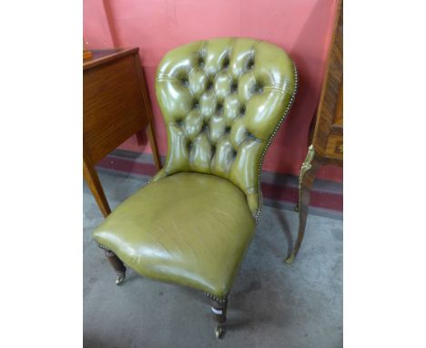 A Victorian mahogany and green leather button-back lady's chair