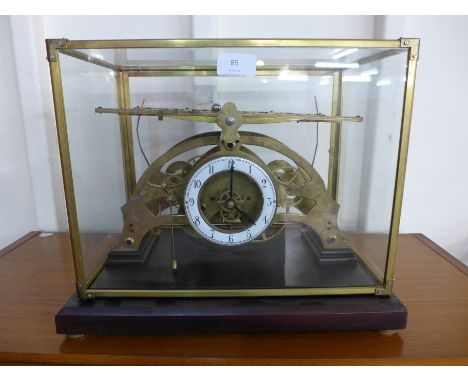 A gilt metal congreve type double sided rolling ball clock, cased