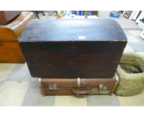 A dome topped trunk and a steamer trunk