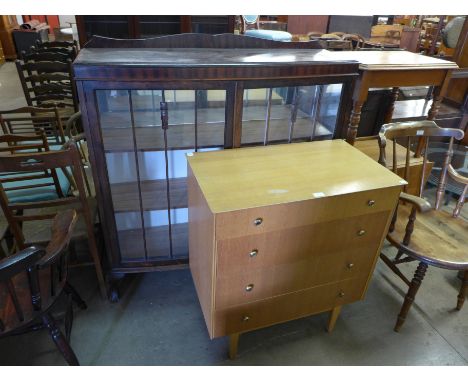 A light oak chest of drawers and a mahogany display cabinet