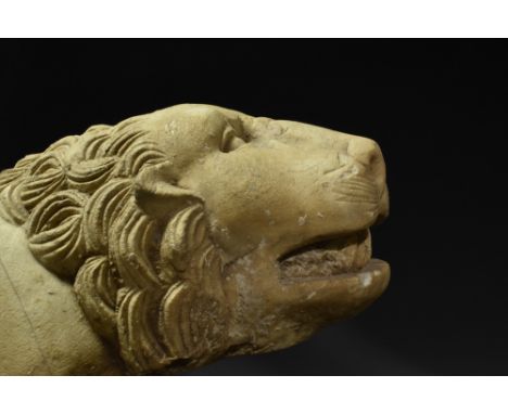 Ca. 100-200 AD.  A fine example of a marble statue of a lion depicted in a crouching position with its legs hidden under the 
