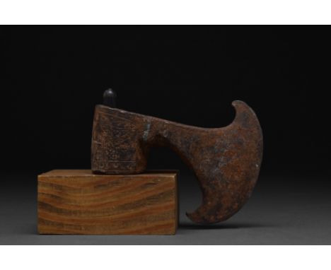 Ca. 1200-700 BC  A cast axe head comprising of a tubular socket with incised decoration, a narrow cheek and a crescentic-shap