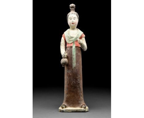 Ca. 618-907 AD  A ceramic figure of a female attendant standing facing forward, with ewer in her right hand. She wears a long