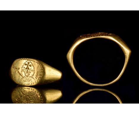 Ca. 500-600 AD  A gold finger ring composed of a round hoop expanding dramatically to form an oval-shaped bezel finely decora