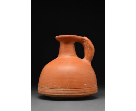 Ca. 1-100 AD  A pottery vessel in the form of a jug with a dome-shaped lower body. The vessel has a squat, cylindrical neck a