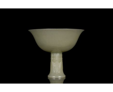Ca. 1368-1644 AD  A beautifully shaped Hetian jade stem cup comprising a deep wide bowl with outturned rim, all resting on a 