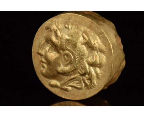 Ca. 300 BC  A gold fitting composed of a discoid plaque with a looped attachment to the rear. The upper face is decorated wit