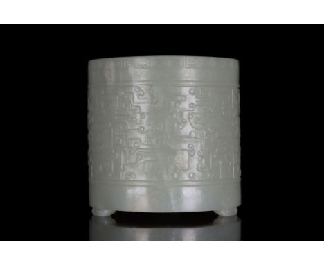 Ca. 1368-1644 AD A cylindrical brush pot skillfully carved from Hetian jade. The vessel sits upon three short legs and is car