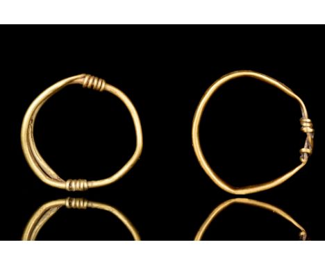 Ca. 200-300 AD  A pair of gold rings of circular-shaped hoops with coiled wiring around its terminals. The item has undergone