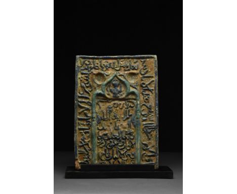 Kashan, Ca. 1100-1200 AD A rectangular-shaped pottery tile with ochre ground decorated with a central motif of pale blue mihr