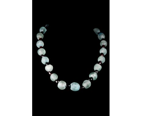 Ca. 100-300 AD  A necklace of Ancient rock crystal and barrel-shaped glass beads. It is striking and in wearable condition. L