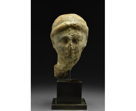 Ca. 1st century BCE - 1st century AD  A marble head of a female with idealized features, her oval face gently sloping to the 