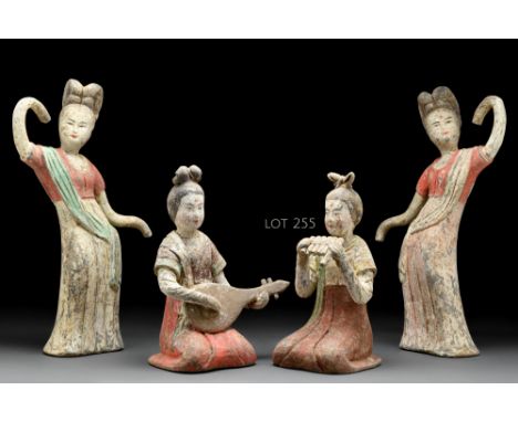 Ca. 618-907 AD  A terracotta female musician figure playing paixiao - the wind instrument, made of edge-blown bamboo pipes, w