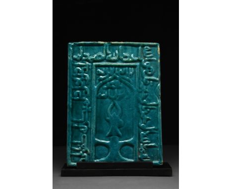 Kashan, Ca. 1100-1200 AD A rectangular-shaped pottery tile covered with turquoise glaze, decorated with low relief lines of c