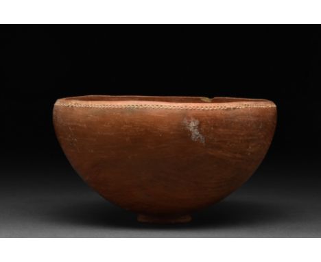 Hellenistic, Ca. 400-300 BC  A beautiful pottery bowl of hemispherical body elegantly flaring out of tiny foot. The basin is 