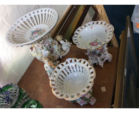 Three ceramic centre pieces with floral and cherub decoration.