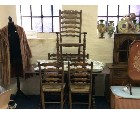 An oak kitchen table along with five ladder backed dining chairs.