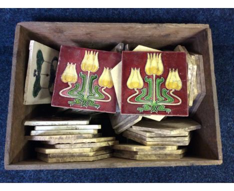 A box of square and hexagonal glazed ceramic tiles with various designs.