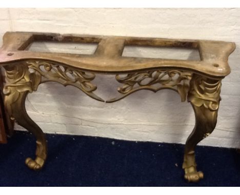 A decorative gilt console table with white marble top.