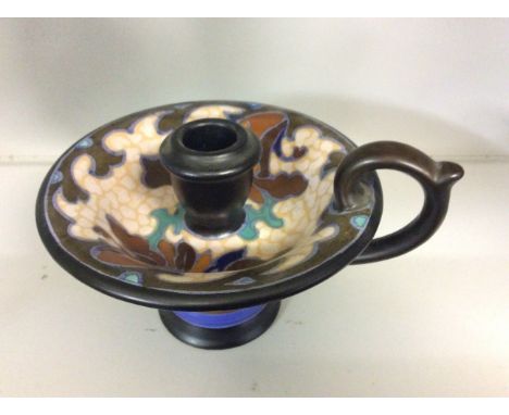 A Gouda pottery candle stick with painted design.