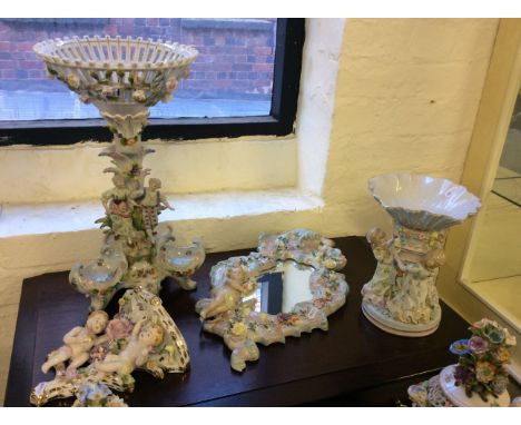 A selection of various ceramic items to include centrepiece, floral mirror and shelf with cherub decoration.