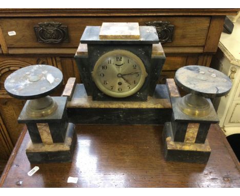 A Art Deco slate and marble mantle clock together with matching candle garnitures.