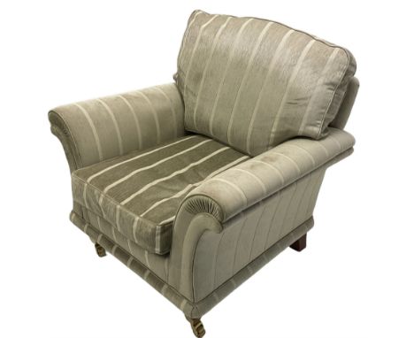 Traditional shaped armchair with scrolled arms, upholstered in pale sage striped fabric, raised on tapered supports with bras