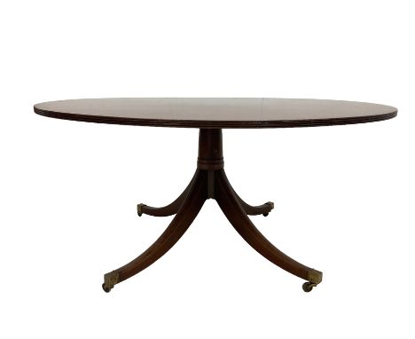 Georgian design mahogany dining table, the circular top with reeded edge, the pedestal carved with stepped turns terminating 