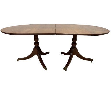 Regency design mahogany twin pedestal dining table, oval top with crossbanding and boxwood stringing, with reeded edge, raise