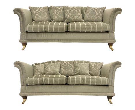 Large pair traditional design drop-arm two seat sofas, shaped back and scrolled arms, upholstered in textured pale sage fabri