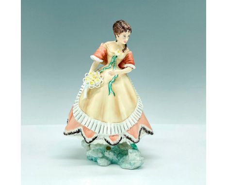 This lovely figurine portrays Penelope in an elegant rose and cream-colored dress, adorned with delicate white ruffles. It's 