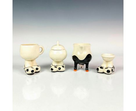 Includes a ceramic footed character egg cup, coffee cup, sugar bowl and creamer. Each item is designed with comical oversized