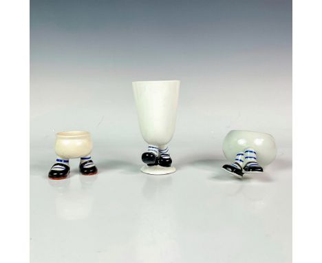 Includes a ceramic footed character egg cup, juice cup, and fruit bowl with comical feet. Vintage hand painted items. Egg cup