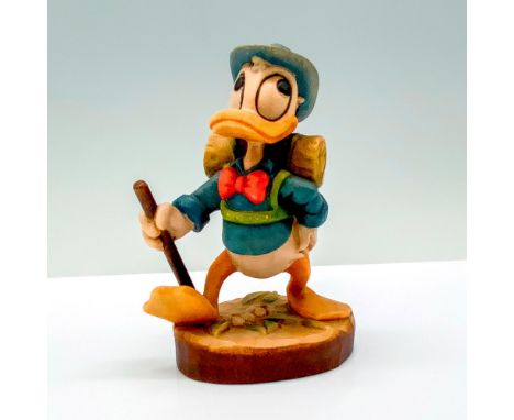 A wooden carved figure of Donald Duck in his classic outfit along with a backpack, hat, and walking stick. Anri backstamp. Wa