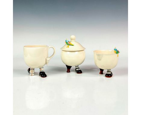 Includes a ceramic footed character coffee cup with comical feet. Also includes sugar bowl with lid and creamer with figural 