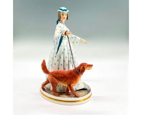 Matte bone china figure of a lady in a light blue dress and hat walking her brown dog. Royal Worcester backstamp. Part of the