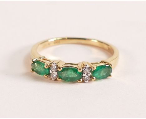 18ct Gold Ring with Marquise cut Emerald and Diamond
The 18ct Gold band is stamped 750 and 18K.  The ring hosts three vivid g