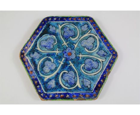 An Antique Syrian Hexagonal Blue Pottery Tile. The cobalt blue and turquoise tile being decorated with a floral design, appro