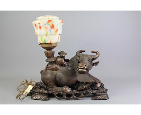 An Antique Chinese Rosewood Carving of a Water Buffalo. The carving depicting a crouching figure now converted to a lamp with