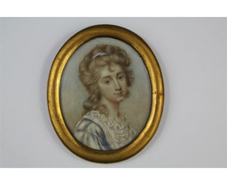 An Antique Portrait Miniature. The oval portrait miniature painted on ivory depicting a young woman, presented in a brass fra