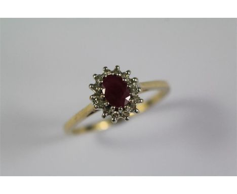 A 9ct Yellow Gold Ruby and Diamond Ring. The oval-cut ruby approx 6 x 4.3mm, approx 14 of 8 cut pts dias, size R, approx 2.4 