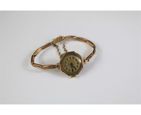 &nbsp;A Lady's 9ct Yellow Gold Wrist Watch. The watch having a engine-turned face with numeric dial on a 9ct gold bracelet, a