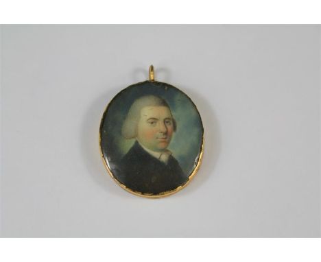 A Fine Georgian Portrait Miniature Pendant. The circular pendant painted on ivory depicts an unknown gentleman in a frock coa