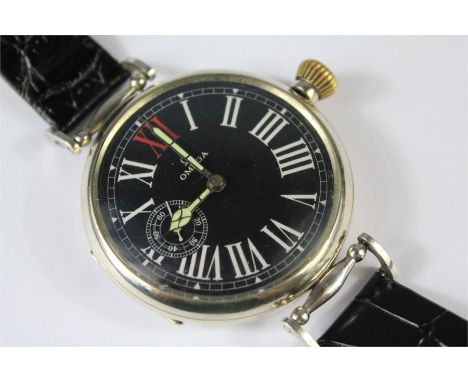 A Circa 1915 Military Omega Watch. The timepiece features an elegant black military dial with red XII marker to white enamele